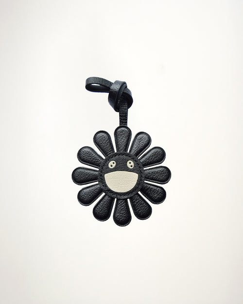 Mochi Manner handmade full-grain sheep leather black daisy bag charm with cream smiley face center