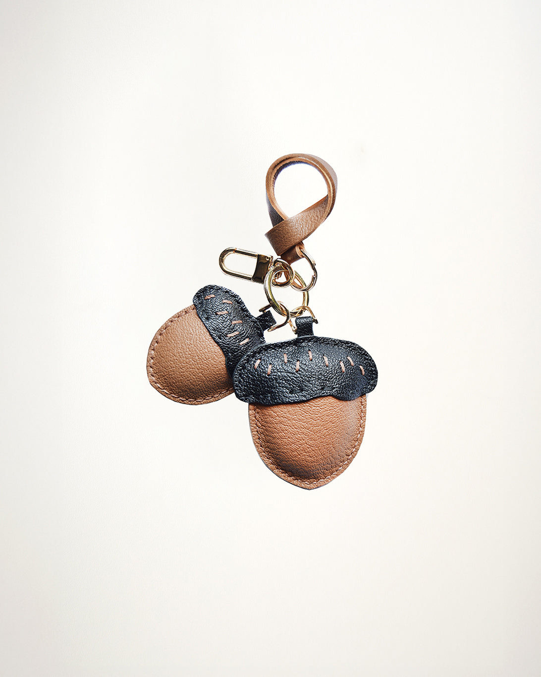 Mochi Manner handmade full-grain leather – sheep skin acorn bag charm in brown and black with gold-plated hardware