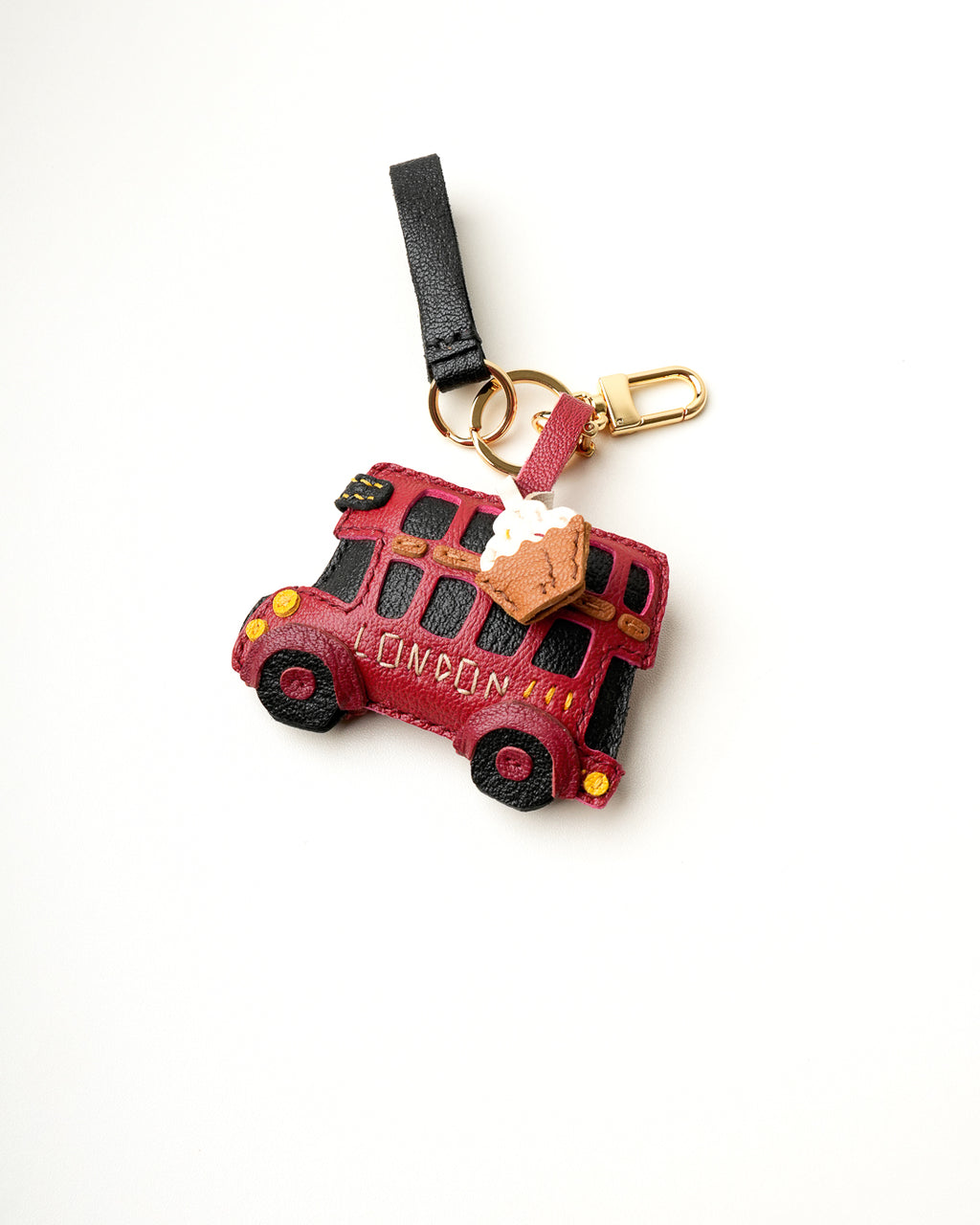 Mochi Manner handmade full-grain leather – sheep skin London bus and pie bag charm in red, black, and tan with gold-plated hardware.