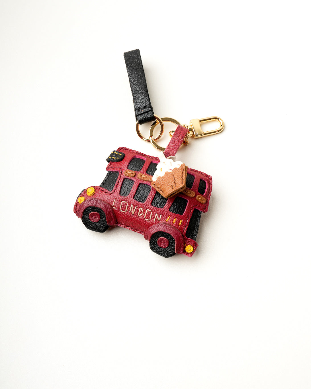 Mochi Manner handmade full-grain leather – sheep skin London bus and pie bag charm in red, black, and tan with gold-plated hardware.